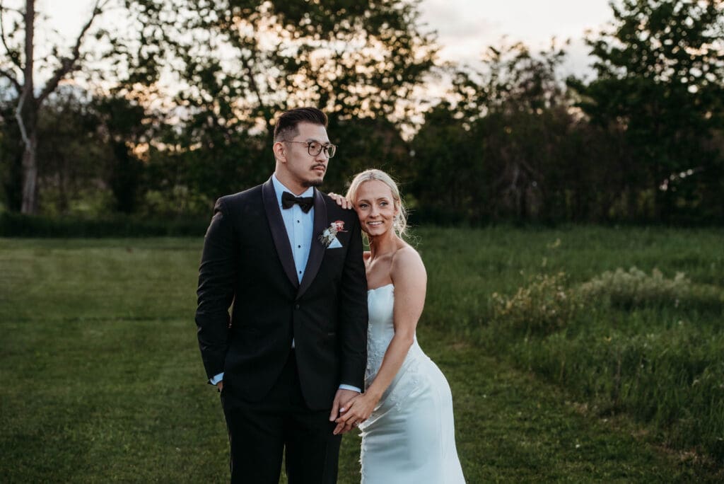A young couple in wedding attire at golden hour